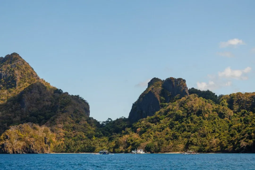 Rounded karst island small boat El Nido