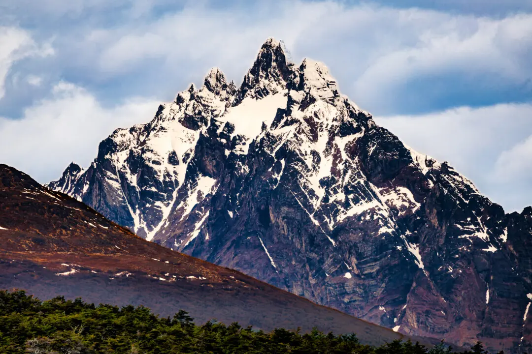 Jagged snow-capped mountain peak against a blue sky in Tierra del Fuego