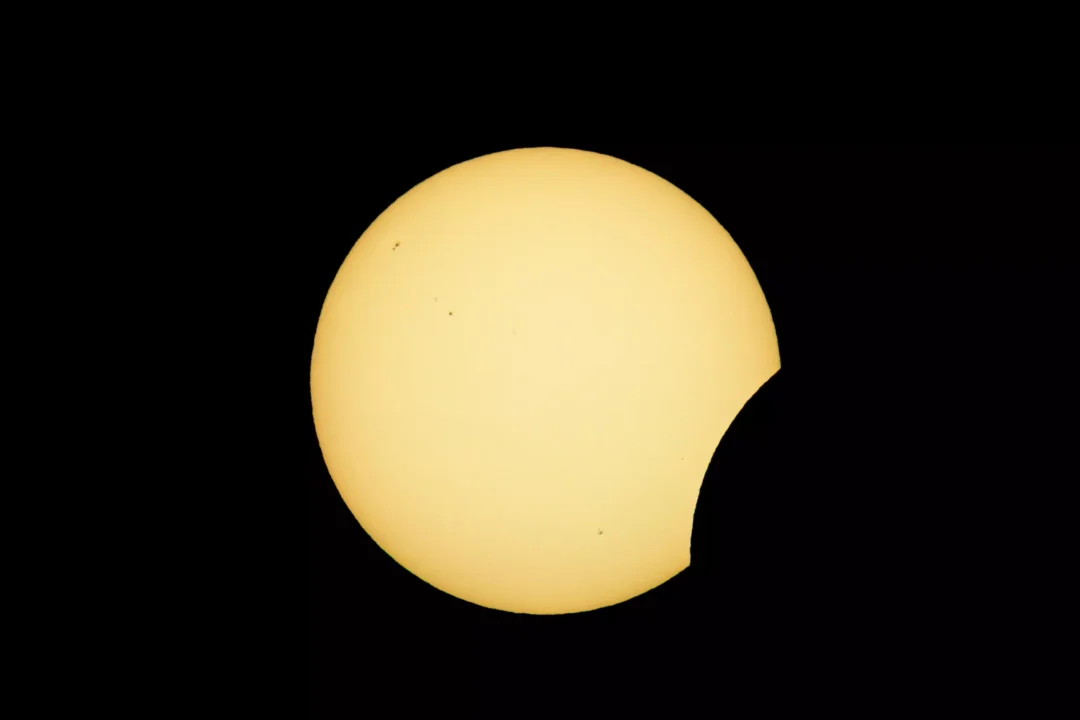The Sun partially obscured by the Moon, forming a growing crescent shape during the 2026 Ibiza solar eclipse