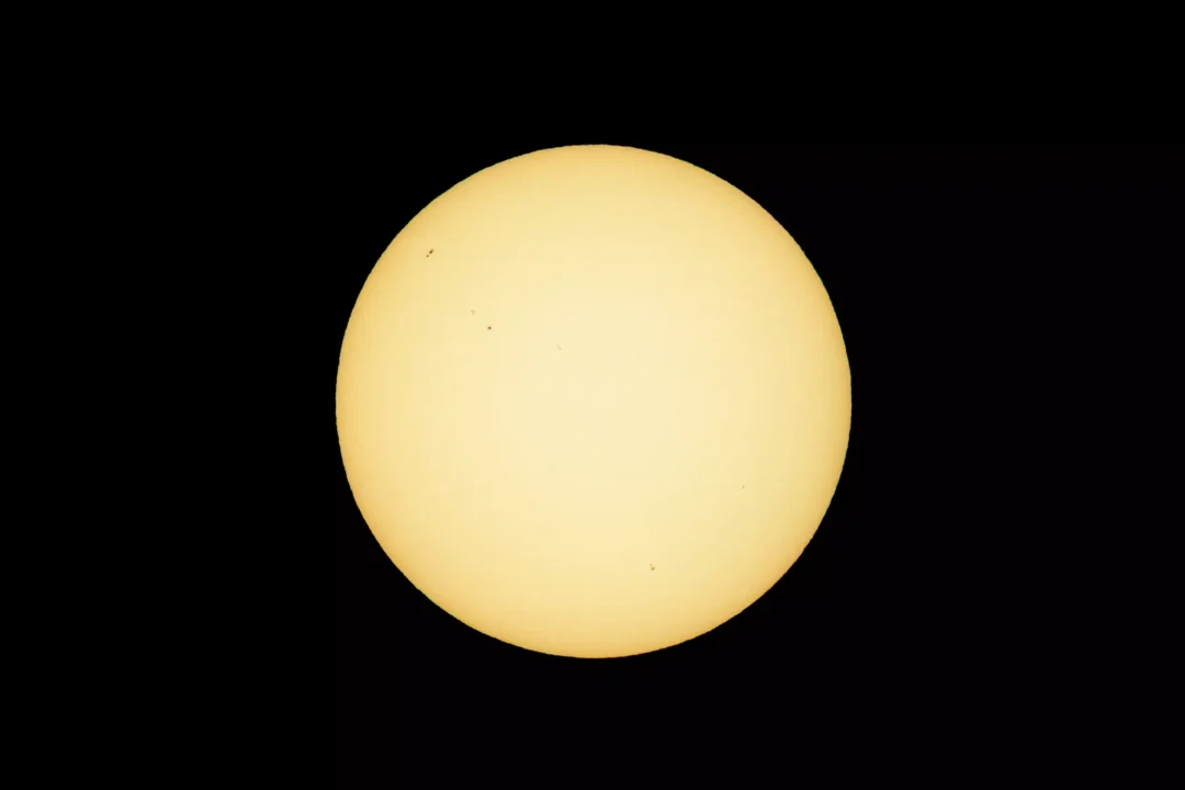Full solar disc showing visible sunspots, photographed through a solar filter before the August 2026 Ibiza eclipse began