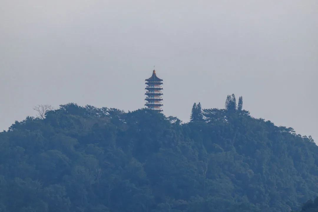 Minimalist silhouette of Ci En Pagoda on a fog-wrapped hill, Sun Moon Lake, Taiwan