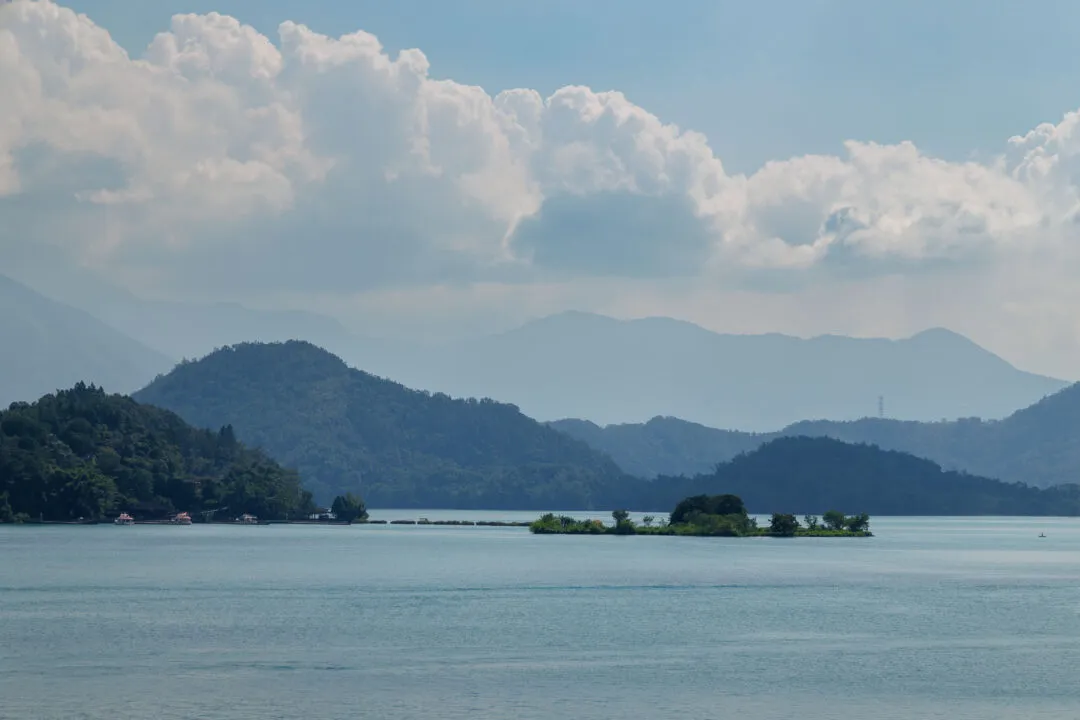 Classic Sun Moon Lake view with a small islet and misty mountain silhouettes, Taiwan