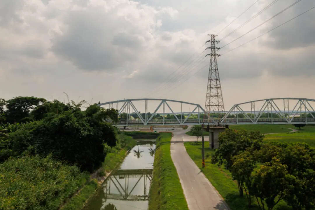 Bridge over a canal under a moody layered sky, Tainan, Taiwan