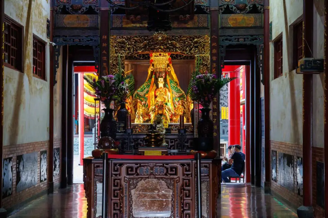Close-up of a gilded temple deity statue in dramatic warm light, Tainan, Taiwan