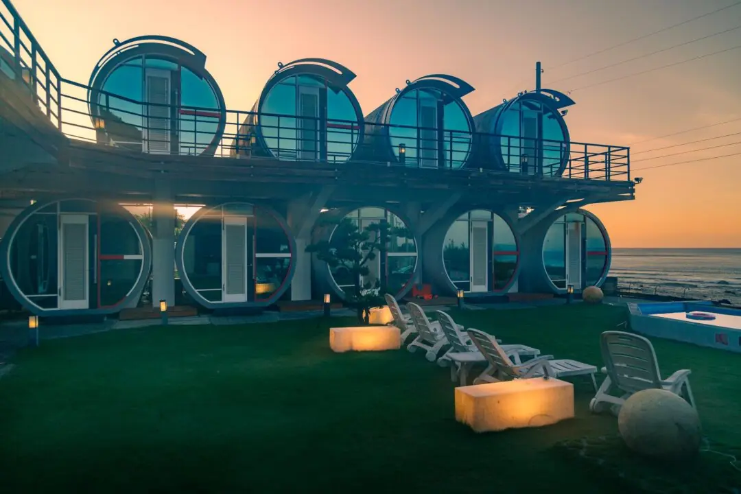 Round pod-style hotel architecture glowing at sunset with ocean beyond, Taitung, Taiwan