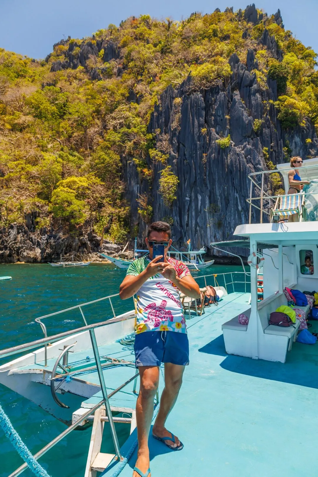 Tandem kayak jagged limestone cliffs El Nido