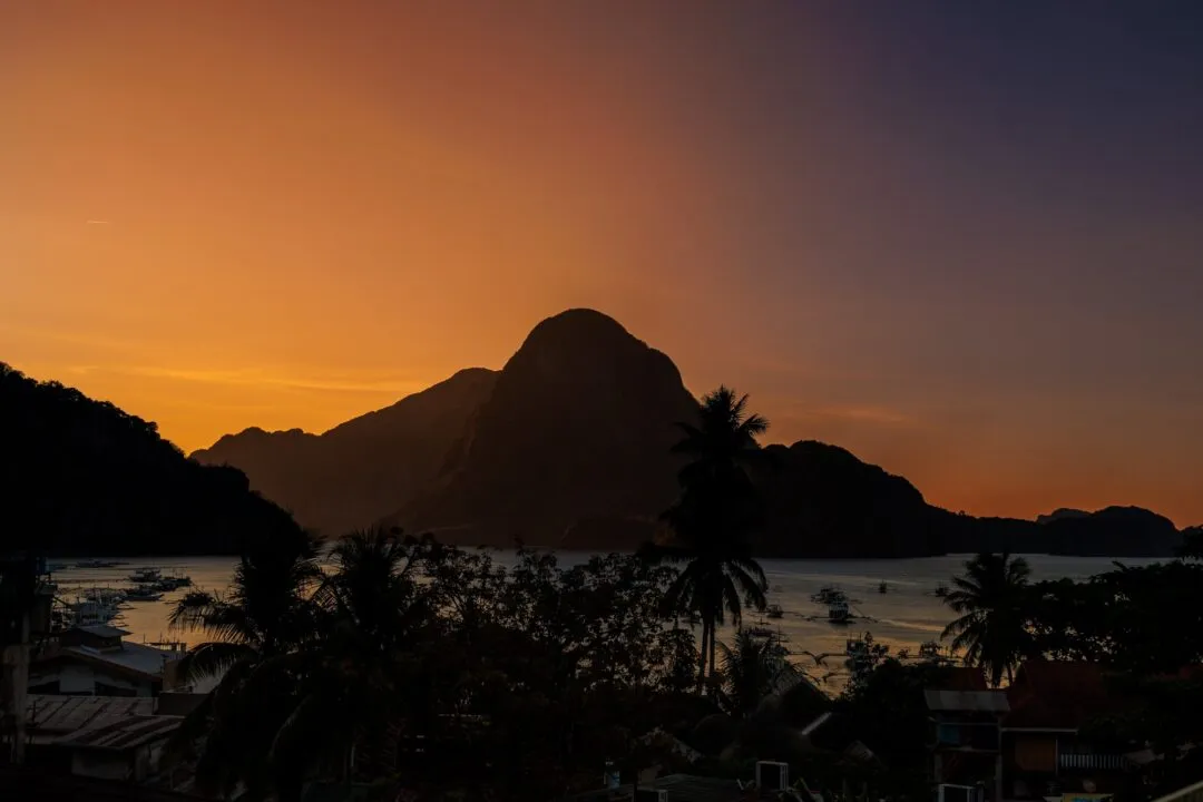 Vivid sunset gradient mountain silhouette El Nido