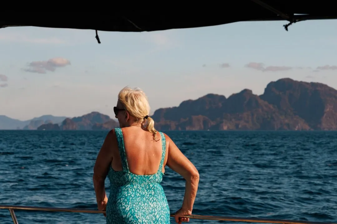 Woman silhouetted boat deck karst blue hour El Nido